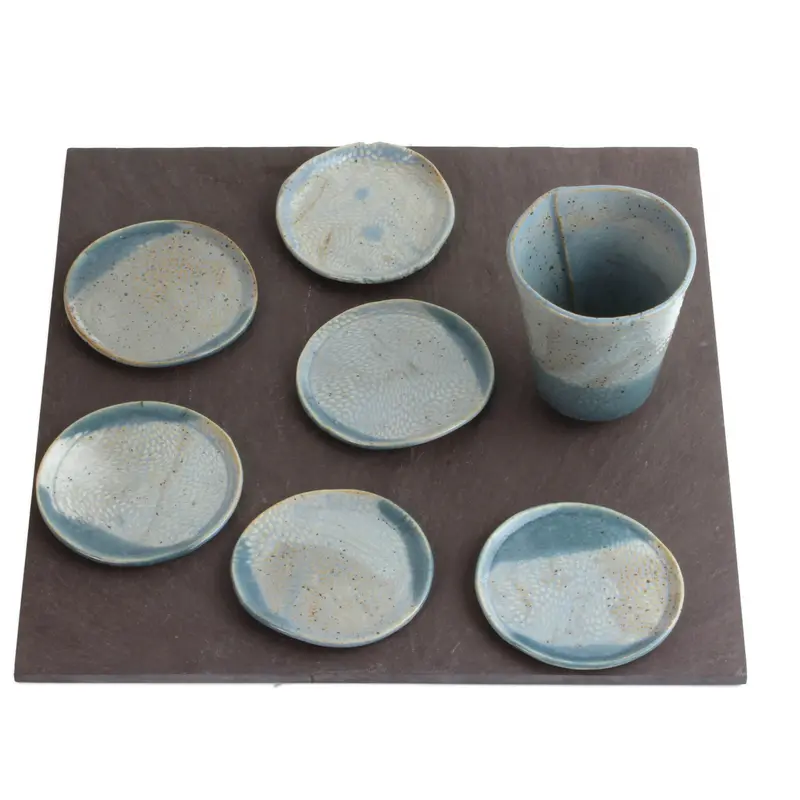 Slate-Based Seder Set: Ceramic Plates And Cups Arranged On Square Natural Slate 1